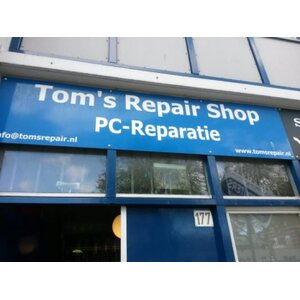 Tom's Repair Shop logo